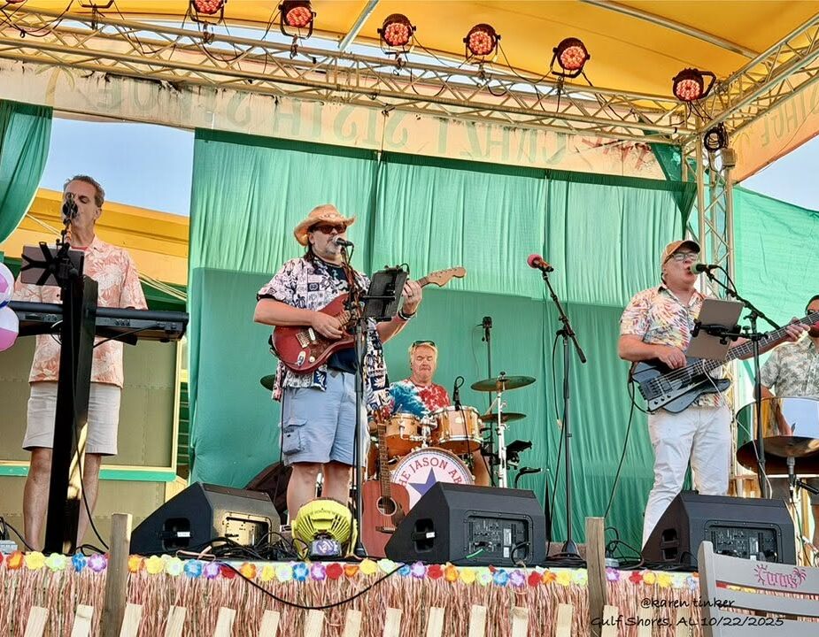 11 Full live band performing indoors under string lights with multiple vocalists and musicians.