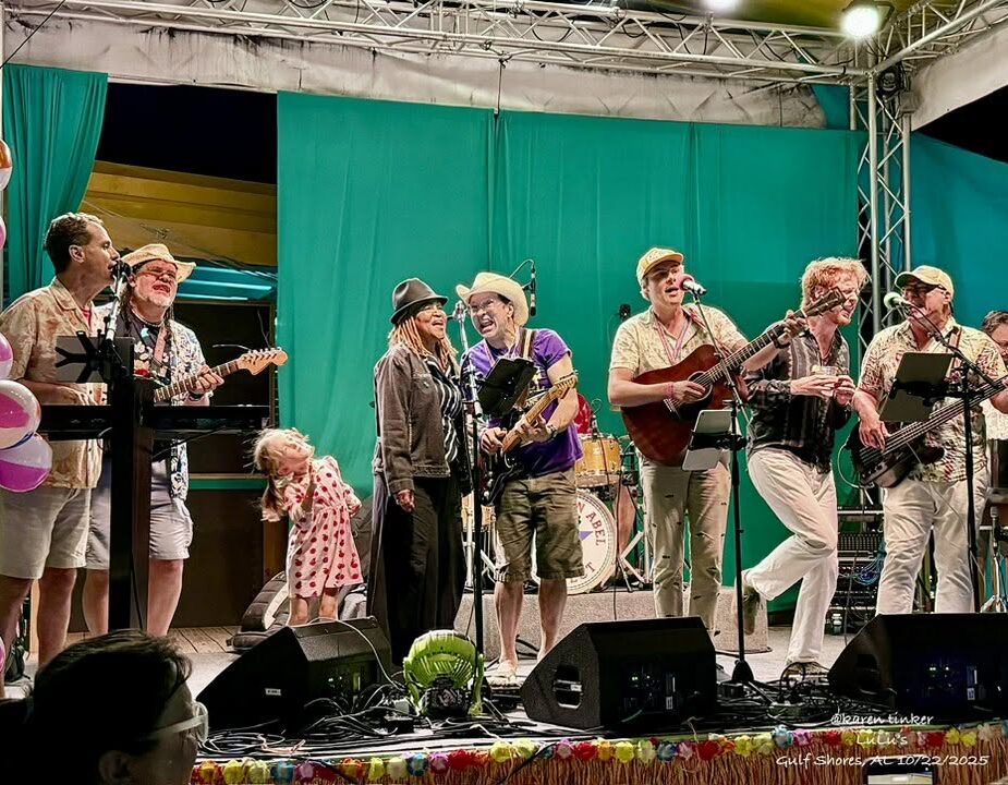 3 Large band and guest performers gathered together onstage during a live show.